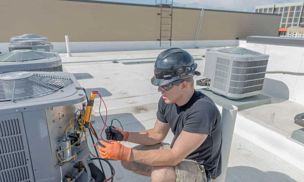 HVAC technician testing rooftop cooling equipment