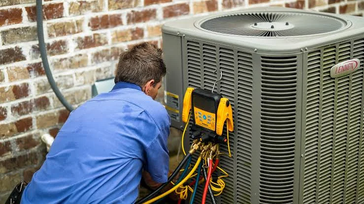HVAC technician inspecting a residential cooling system in Little Elm, Texas